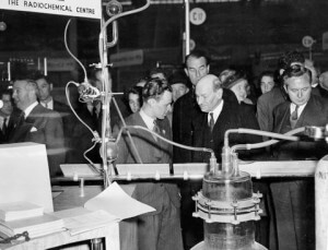 Paul Carter of the Fission Product Team talking to Clement Attlee with Harold Wilson at an exhibition stand in the 1940s