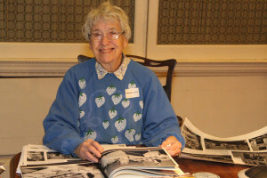 Marjory Foyle looking at old photos in The Library