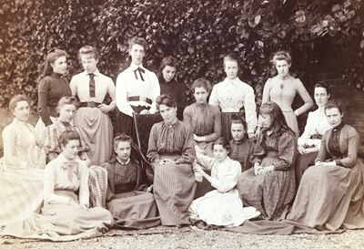 Madeline Agar seated on the ground in white dress in the middle, 1890, courtesy of Wimbledon High School
