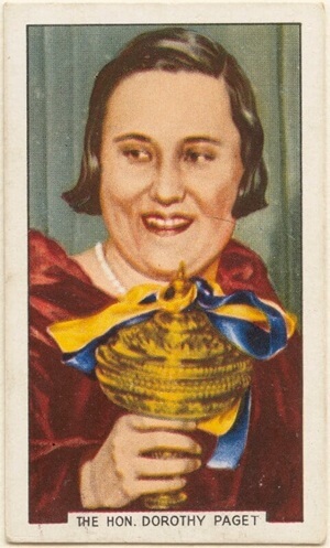 1936 Cigarette Card of Dorothy Paget, holding the Grand National Cup which she won in 1934 with her horse Golden Miller